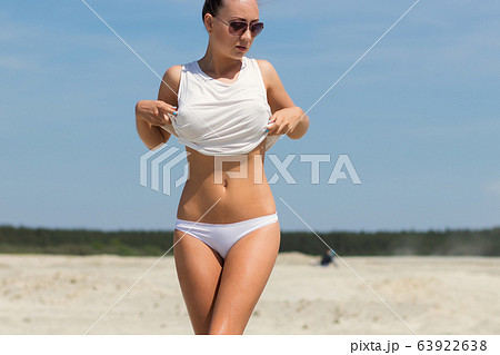 Sexy woman on windy day on beach 63922638