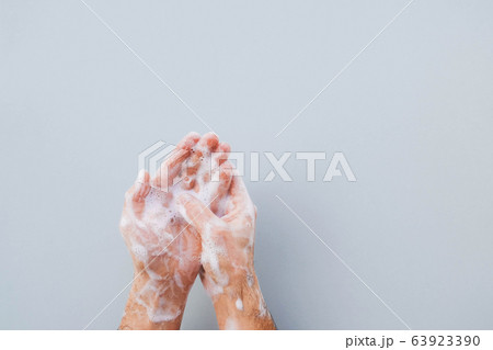 Man cleaning his hands using liquid disinfectant soap. Man cleaning his hands using liquid disinfectant soap. 63923390