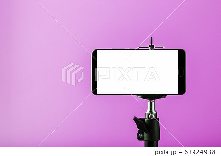 Mobile phone on a tripod with a clear white Mobile phone on a tripod with a clear white 63924938