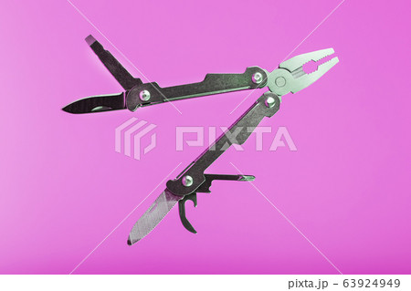Multitool is a multi-functional tool on a pink Multitool is a multi-functional tool on a pink 63924949