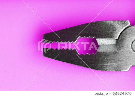 Multitool is a multi-functional tool on a pink 63924970