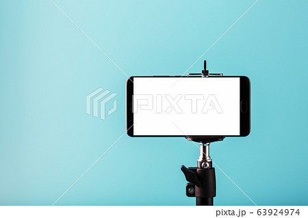 Mobile phone on a tripod with a clear white 63924974