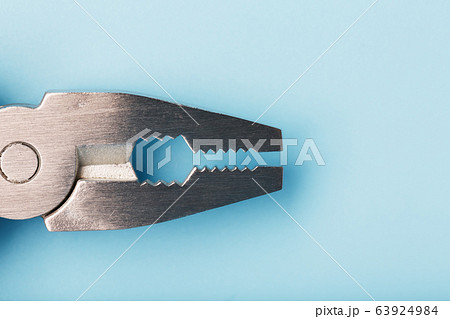 The multitool multi-function tool hovers on a blue 63924984