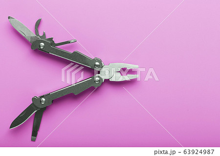 Multitool is a multi-functional tool on a pink 63924987