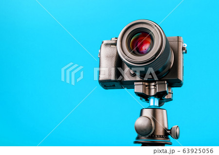 Professional camera on a tripod, on a blue Professional camera on a tripod, on a blue 63925056