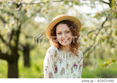 Portrait young attractive woman with curly hair in 63925490