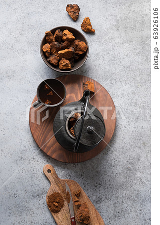 Chaga infusion beverage in cup on grey 63926106