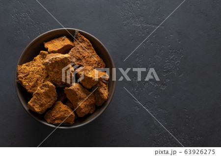 Chaga Birch Mushrooms in bowl on black table. 63926275