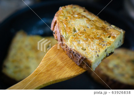 Toasted golden bread slice on wooden bakery shovel Toasted golden bread slice on wooden bakery shovel 63926838