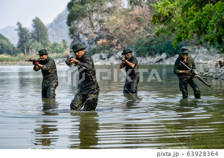 Group of soldier men and woman are walking and point gun forward to the enemy 63928364