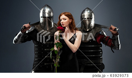 Beautiful girl in a black dress and knights in 63929373