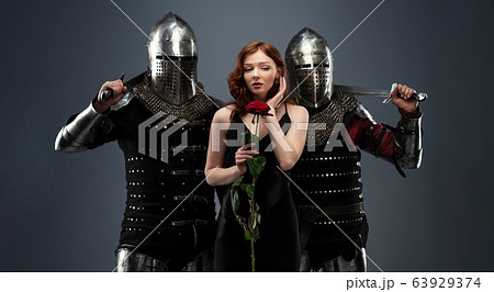 Beautiful girl in a black dress and knights in Beautiful girl in a black dress and knights in 63929374