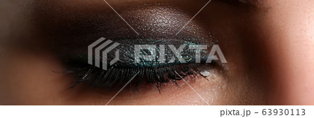 Closed eyes of beautiful woman wearing party makeup 63930113