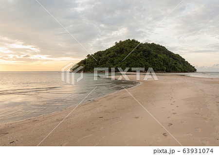 Tropical island and paradise beach at sunset Tropical island and paradise beach at sunset 63931074
