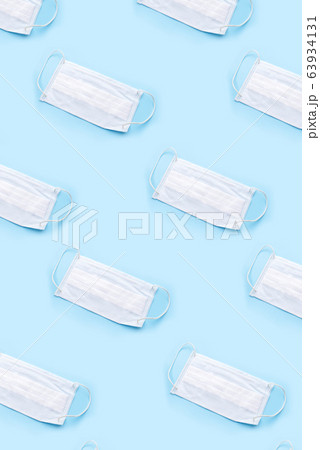 Disposable medical mask on blue background. 63934131