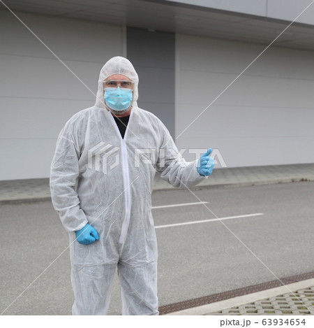 Protected worker wearing glasses, mask and gloves 63934654