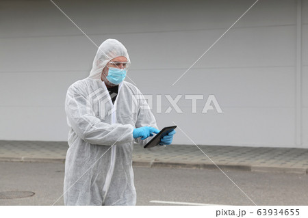 Protected worker wearing glasses, mask and gloves 63934655