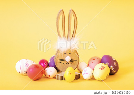 Wooden Easter Bunny with Easter eggs, on an 63935530