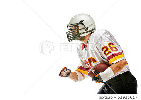 American football player posing with ball on black background. Super Bowl concept. Concept American football, portrait American, Motivator. Black white background, copy space. Isolate American football player posing with ball on black background. Super Bowl concept. Concept American football, portrait American, Motivator. Black white background, copy space. Isolate 63935617