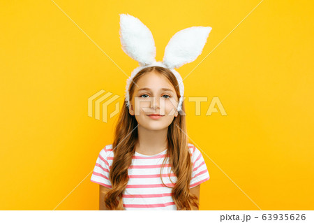 Happy little beautiful girl on her head with 63935626
