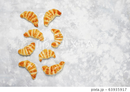 Fresh tasty homemade croissants on grey-white background. French pastry Fresh tasty homemade croissants on grey-white background. French pastry 63935917