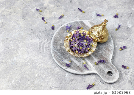 Assortment of dry tea in golden vintage mini plates.Tea types background:hibiscus,chamomile,mixed black tea,dry roses,butterfly pea tea Assortment of dry tea in golden vintage mini plates.Tea types background:hibiscus,chamomile,mixed black tea,dry roses,butterfly pea tea 63935968