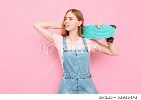 stylish attractive girl smiling and holding a stylish attractive girl smiling and holding a 63936143