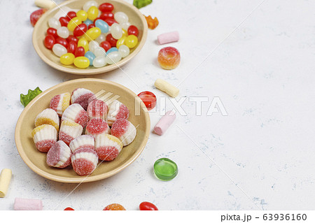 Colorful candies, jelly,marshmallow on light background. Top view with copy space Colorful candies, jelly,marshmallow on light background. Top view with copy space 63936160