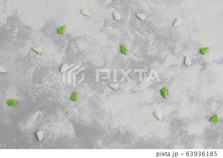christmas tree shaped sparkle candies on a gray table. Top view, flat lay 63936185
