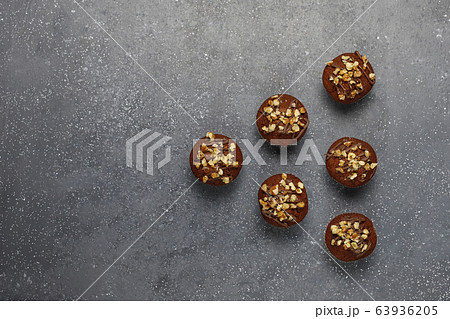 Chocolate-walnut muffins with coffee cup with walnuts on dark background ,Selective Focus. 63936205