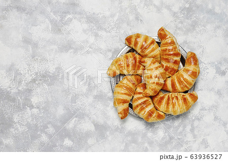 Fresh tasty homemade croissants on grey-white background. French pastry Fresh tasty homemade croissants on grey-white background. French pastry 63936527