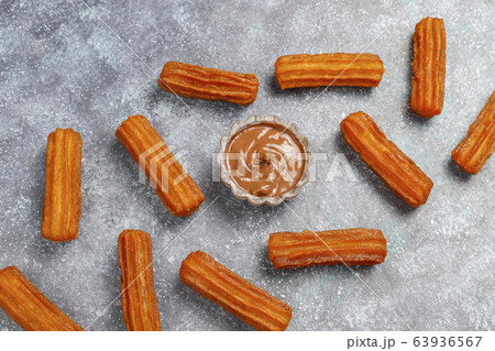 Traditional Mexican dessert churros with chocolate,top view Traditional Mexican dessert churros with chocolate,top view 63936567