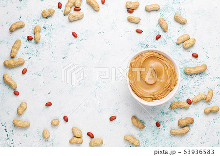 Homemade peanut butter with peanuts on grey concrete background,top view 63936583