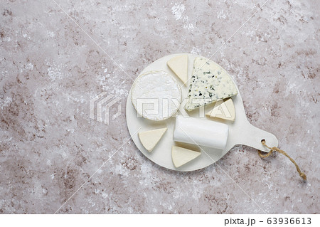 Various types of cheese on light brown background,top view Various types of cheese on light brown background,top view 63936613