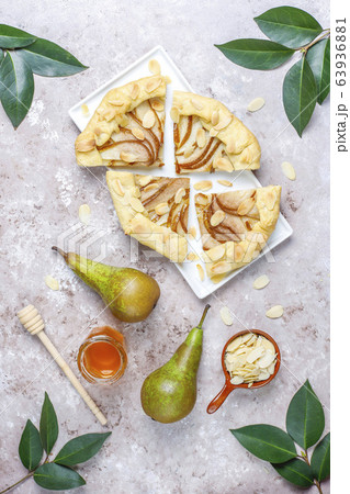 Homemade pear galette pie with almond leaves and fresh ripe green pears Homemade pear galette pie with almond leaves and fresh ripe green pears 63936881