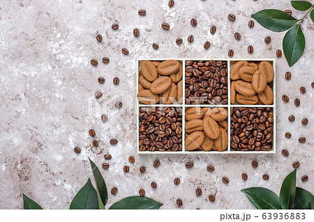 Composition with roasted coffee beans and coffe bean shaped cookies Composition with roasted coffee beans and coffe bean shaped cookies 63936883