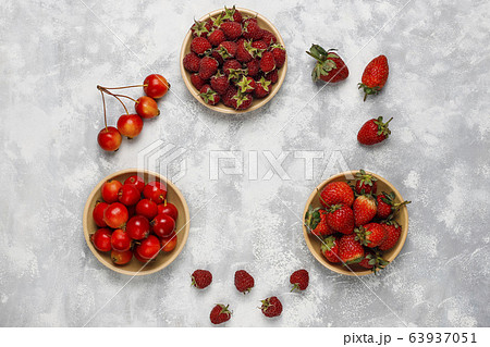 Fresh organic berries on grey concrete background,top view,copy space Fresh organic berries on grey concrete background,top view,copy space 63937051