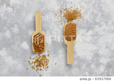 Various types of brown sugar on concrete background,top view Various types of brown sugar on concrete background,top view 63937066