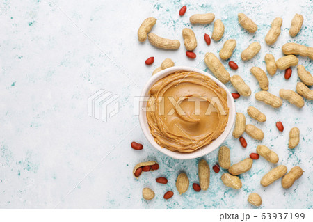 Homemade peanut butter with peanuts on grey concrete background,top view 63937199