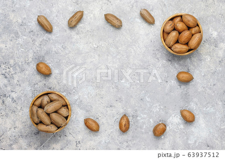 Pecan nuts on light background,top view Pecan nuts on light background,top view 63937512