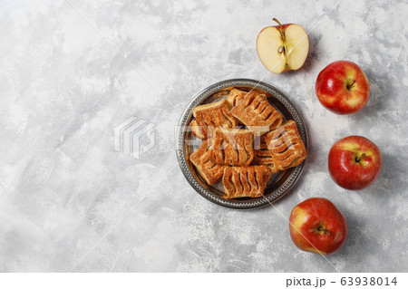 Puff pastry cookies filled with Apple jam and fresh red apples on light concrete background Puff pastry cookies filled with Apple jam and fresh red apples on light concrete background 63938014