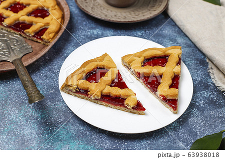 Delicious traditional berry cherry pie Crostata on grey dark background Delicious traditional berry cherry pie Crostata on grey dark background 63938018