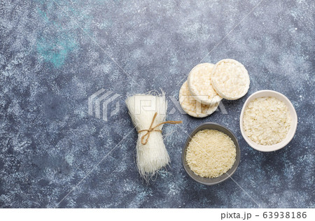 Rice flakes,rice noodles,rice bread and rice on dark background,top view 63938186