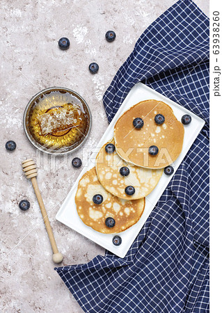 blueberry pancakes on brown light background,top view 63938260