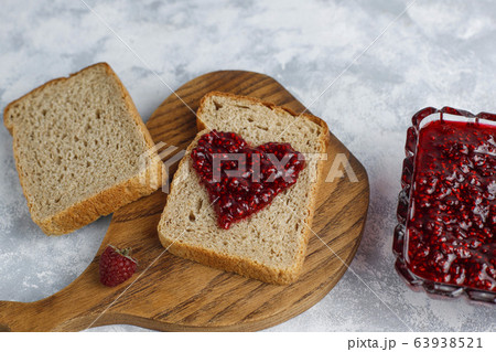 homemade raspberry jam with fresh raspberries on concrete background,top view homemade raspberry jam with fresh raspberries on concrete background,top view 63938521
