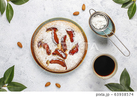 Homemade rustic plum cake with powdered sugar and almond,top view Homemade rustic plum cake with powdered sugar and almond,top view 63938574