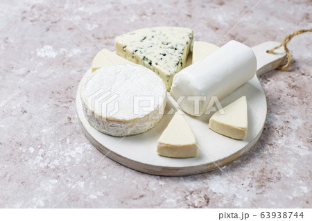 Various types of cheese on light brown background,top view Various types of cheese on light brown background,top view 63938744