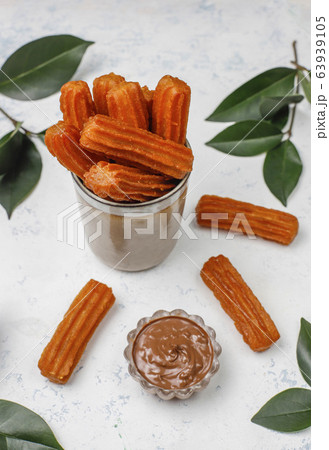 Traditional Mexican dessert churros with chocolate,top view 63939105