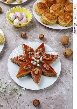 Traditional Azerbaijan sweets shakarbura,bakhlava,qogal,mutaki cookies on light background,Azerbaijan holiday Novruz background. Traditional Azerbaijan sweets shakarbura,bakhlava,qogal,mutaki cookies on light background,Azerbaijan holiday Novruz background. 63939158
