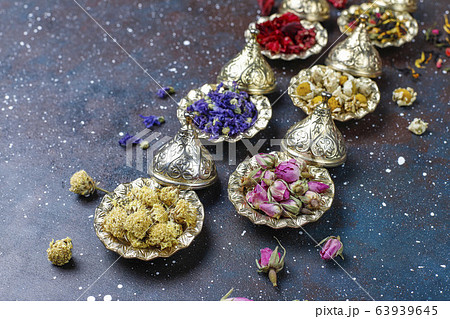Assortment of dry tea in golden vintage mini plates.Tea types background:hibiscus,chamomile,mixed black tea,dry roses,butterfly pea tea 63939645